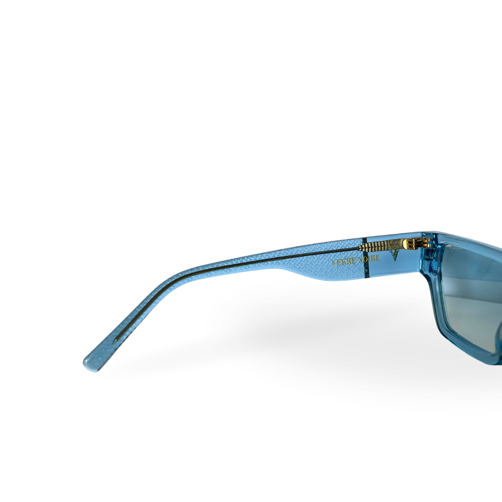 View of Capri Frame sunglasses in clear blue acetate inner arm showing gold hinges