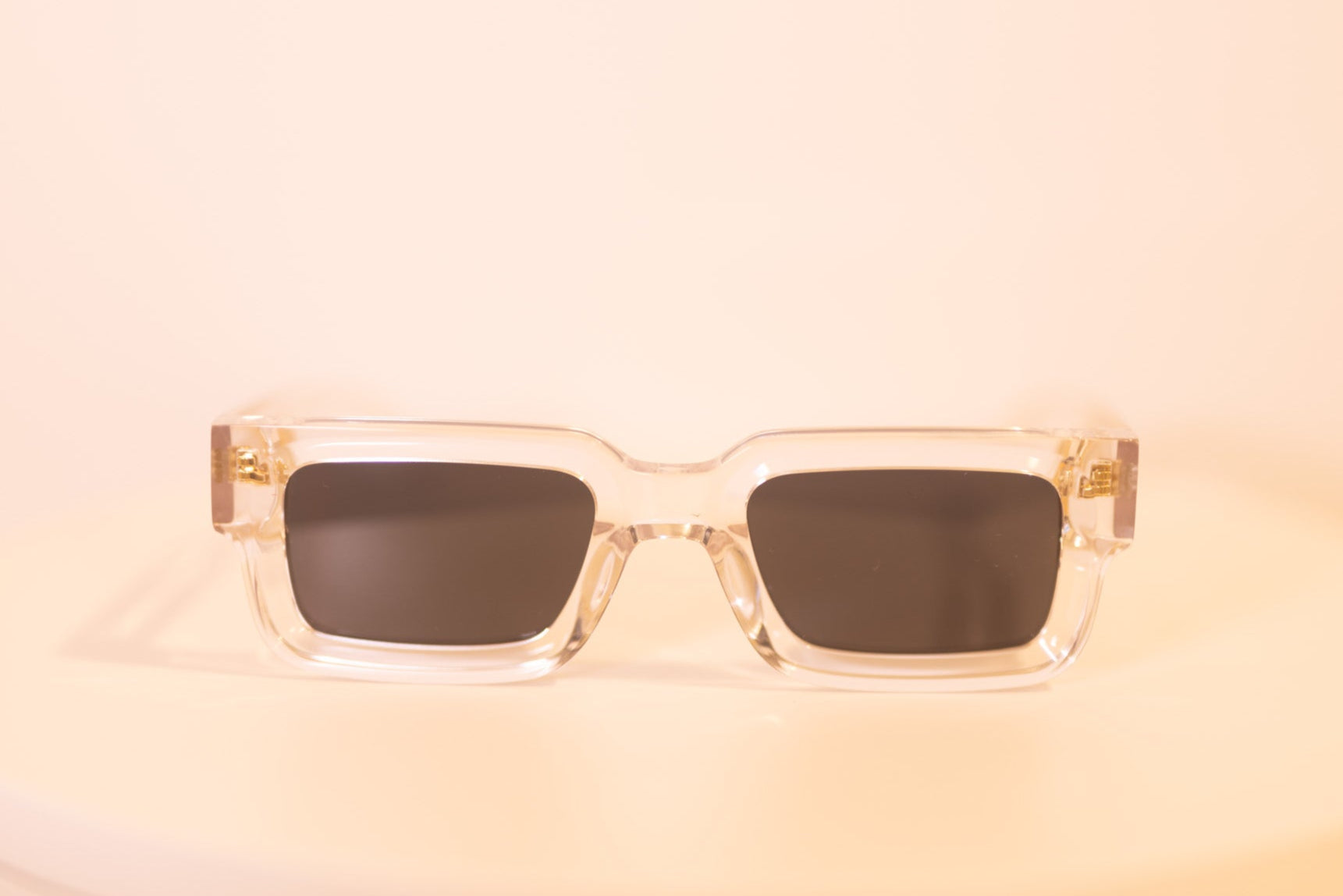 Crystal Elite sunglasses front view with transparent frame and gold accents