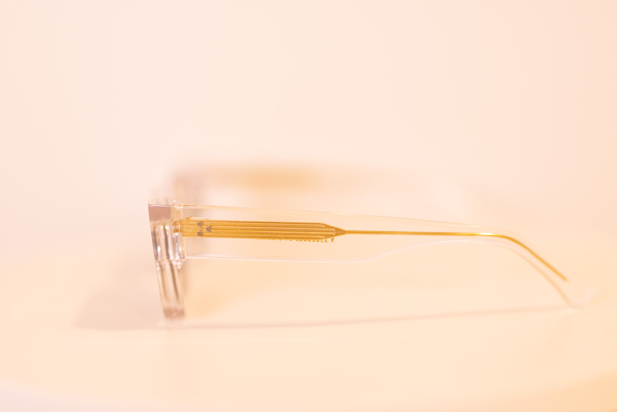 Side profile of Crystal Elite sunglasses showcasing gold-core arm design