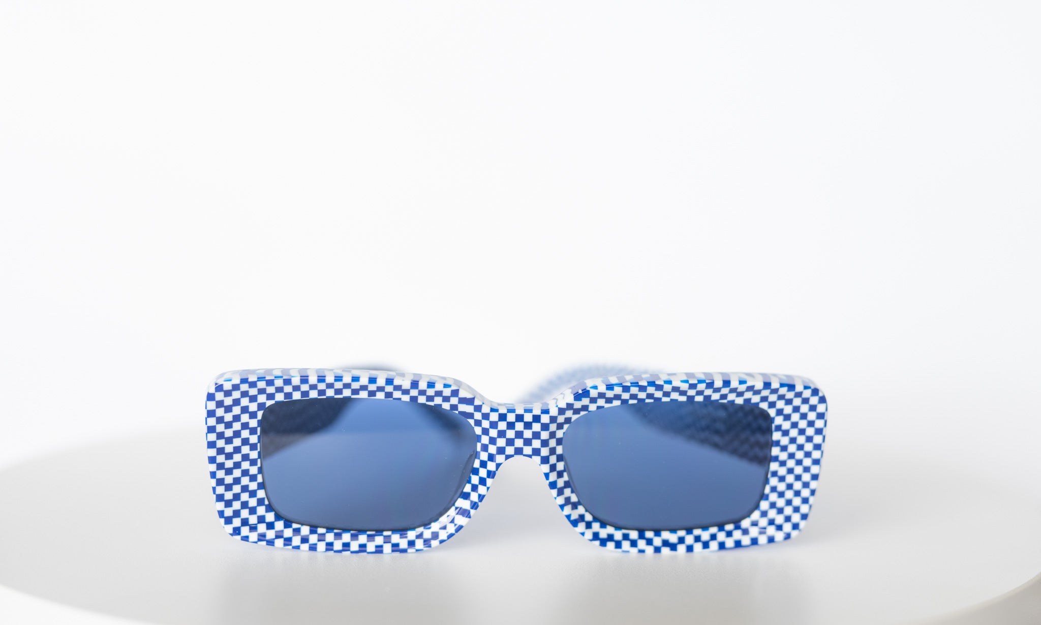 Checkmate Blue sunglasses with blue lenses and sculpted shape

