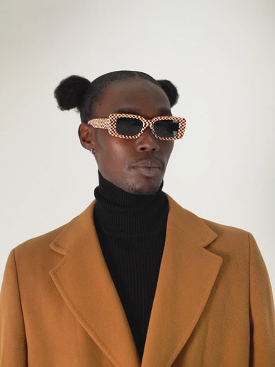 Model wearing Checkmate Orange unisex sunglasses – bold square frame
